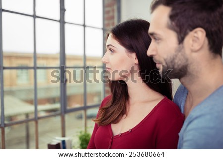 Close up Romantic Young Couple Looking Afar Through Glass Window.