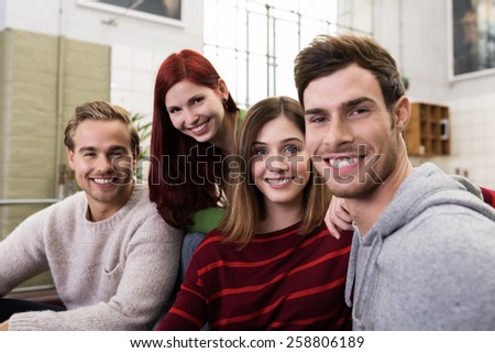 Close up Circle of Young Adult White Friends in Casual Outfits Looking at the Camera with Happy Facial Expression.