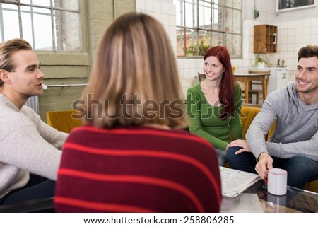 Circle of Young Adult White Friends Talking Happy Topics at the Lounge Room During their Free Time.