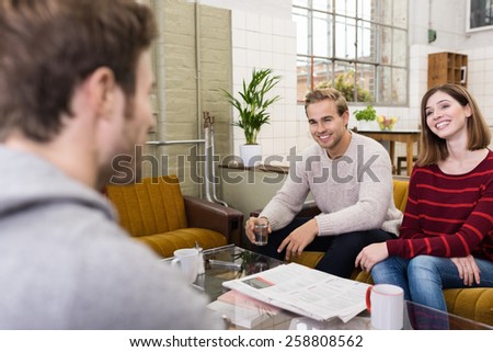 Young White Friends Relaxing at the Lounge Room While Sharing Happy Moments During their Break Time.