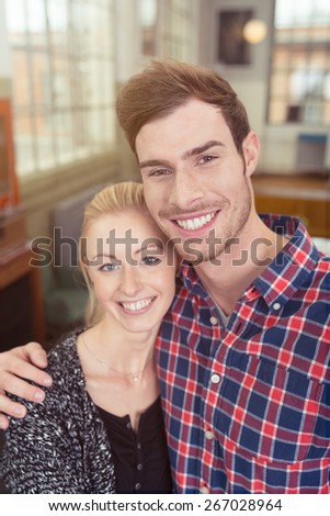 Close up Portrait of Happy Sweet Young White Couple Looking at the Camera with a Toothy Smile.