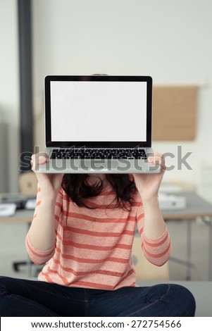 Close up Woman in Casual Orange Stripe Shirt Covering her Face with Empty White Laptop Screen, Emphasizing Copy Space.