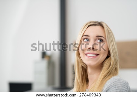 Close up Face of a Happy Thoughtful Blond Woman Looking to Upper Right of the Frame