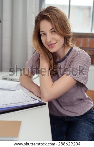 Pretty Blond Teen Girl Sitting at her Personal Study Table Inside the House with Notes for Her Lessons.