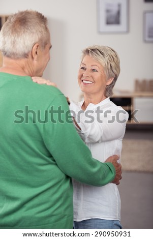 Happy In Love Middle Aged Couple Dancing So Sweet While Looking Each Other in Living Room.