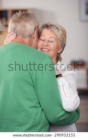 Close up Romantic Middle Aged Couple Embracing One Another While Dancing Sweet Music Inside the House.