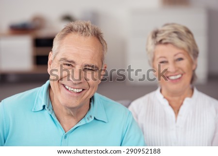Close up Cheerful Middle Aged Husband Beside his Happy Wife, Smiling at the Camera.