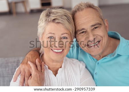 Close up Portrait of a Sweet Cheerful Middle Aged Husband and Wife Smiling at the Camera