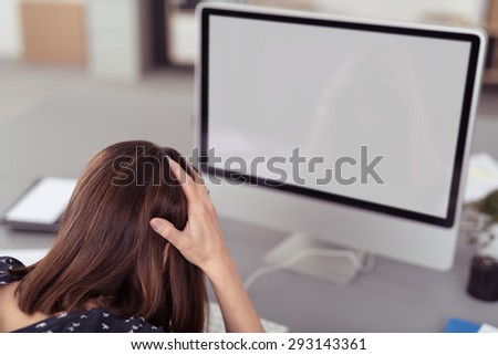 rear View of an Office Woman Gets Annoyed to her Computer with White Blanks Screen on Top of her Desk.