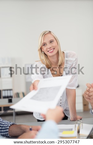 Young Office Woman in a Board Meeting, Passing a Business Document to Co-Worker with Happy Facial Expression.