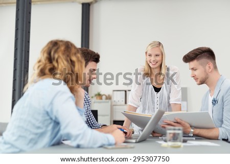Cheerful Woman Taking the Lead to a Business Meeting to Young Professionals Inside the Boardroom