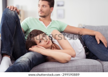 Contented Brunette Woman Lying on Sofa and Looking Relaxed with Head in Mans Lap, Happy Couple Sitting on Sofa Together