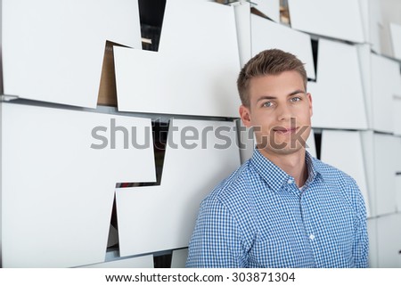 Close up Smiling White Handsome Guy Standing Beside Office Cabinets, Smiling at the Camera.
