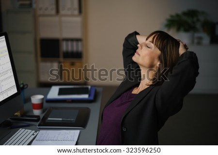 Tired Businesswoman Sitting at her Desk, Takes a Short Break to Relax While Working on her Computer.