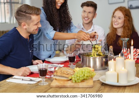 Group of Four Young Friends Having a Dinner Together While Celebrating Something.