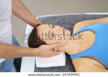Close up Young Woman Having a Head Massage Therapy by a Physical Therapist with Eyes Closed.