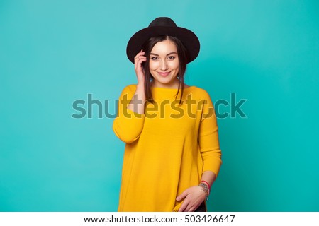 Trendy sexy young woman wearing casual clothes posing over green background