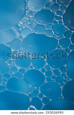 Bubble of oil and water in blue background, shot with macro lens.There are many macro bubble inside the big one.