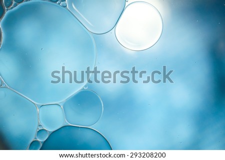 Bubble of oil and water in blue background, shot with macro lens.There are many macro bubble inside the big one.