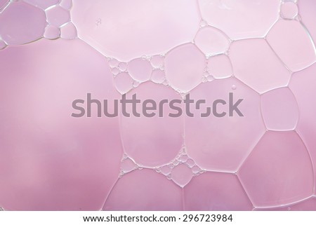 Bubble of oil and water in pink background, shot with macro lens. There are many tiny bubbles inside. (Resend due Title)