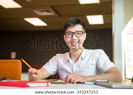 Young male student studies for the examination in university