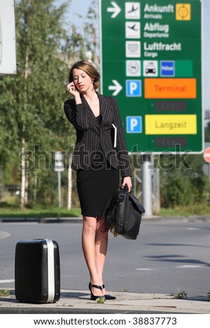 Business Woman waiting and telephones at the airport