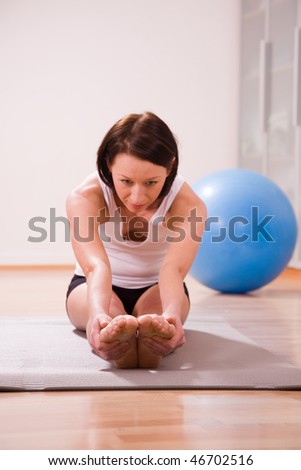 young woman with stability ball doing gymnastik sport coach