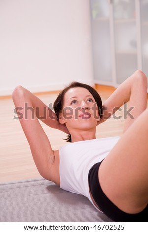 young woman with stability ball doing gymnastik sport coach