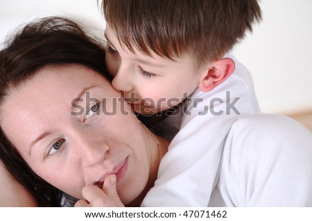 young boy whispers her mother in Ears