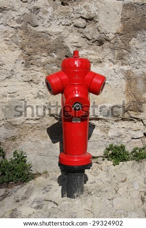 fire hydrant in front of old wall in Provence, france