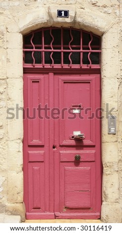 Old pink door Number 1 in Tarascon, Provence, France