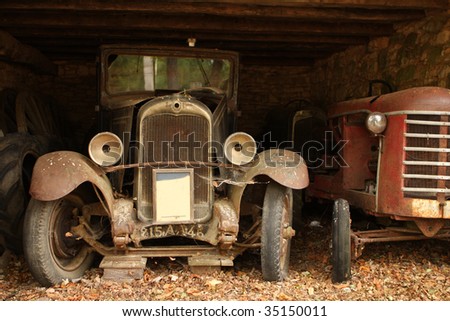 stock photo Forgotten old vintage cars in barn dordogne france