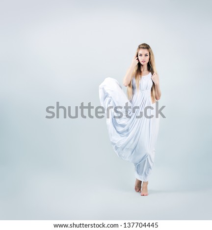 Aphrodite Styled Woman in Waving White Dress. Ancient Greek Goddess.