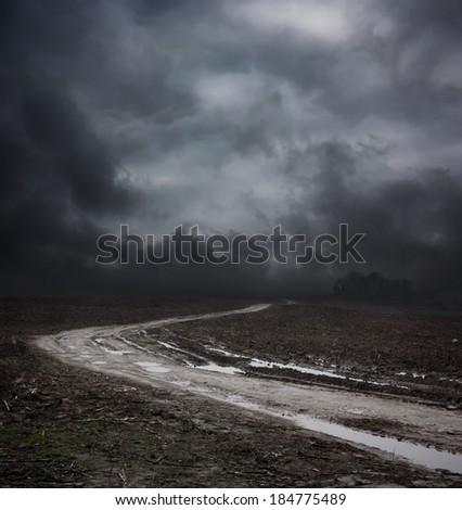 Dark Landscape with Dirty Road and Moody Sky. HDR Cloudscape.