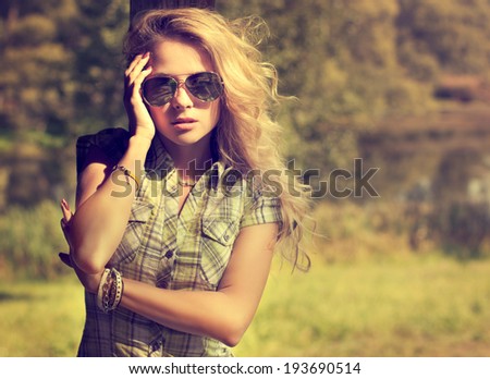 Trendy Hipster Girl in Sunglasses Touching Her Face. Summer Modern Youth Lifestyle. Toned Photo.