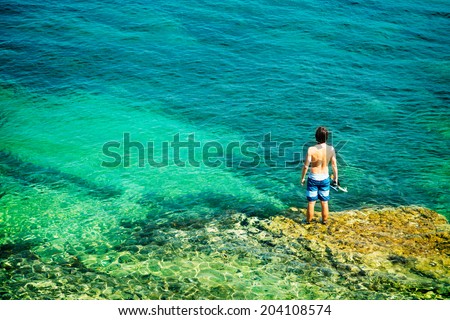 Young Man with Diving Mask Standing in Clear Sea. Healthy Lifestyle Concept. Summer Vacation. Copy Space.