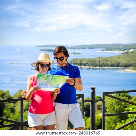 Happy Couple Looking at the Map. Summer Sea Background with Islands. Copy Space. Travel and Vacation Concept.