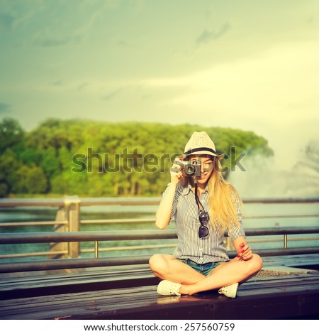 Portrait of Young Hipster Girl Making Photo with Vintage Camera. Modern Youth Lifestyle Concept. Toned Instagram Styled Photo.