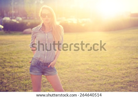 Trendy Hipster Girl in the City at Sunset. Urban Fashion Concept. Toned and Filtered Photo. Copy Space.