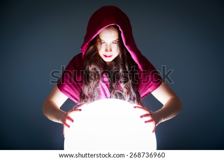 Fortune Teller Looking in a Magic Crystal Ball. Future Prediction. Beautiful Copy Space for your Logotype or Concept in the White Glowing Ball.