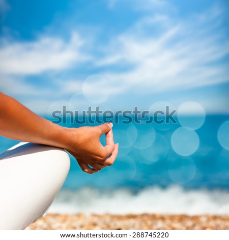 Yoga Hand on Sea Background. Healthy Lifestyle Concept. Beautiful Photo with Bokeh. Shallow Depth of Field.
