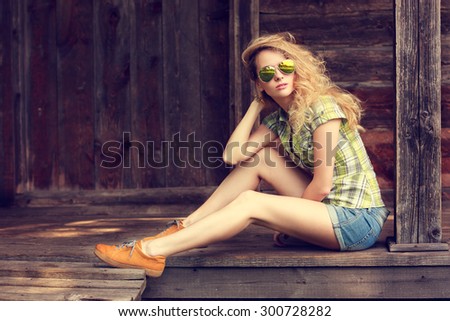 Street Style Fashion Woman Outdoors. Toned Photo with Copy Space. Wooden Background.