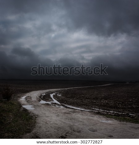 Night Landscape with Country Road and Dark Clouds. Moody Sky Background.