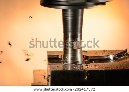 Milling cutter work with splinters flying off on a light background