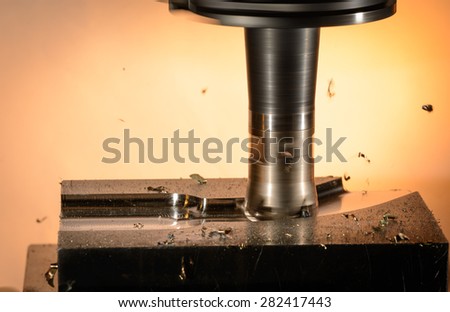 Milling cutter work with splinters flying off on a light background