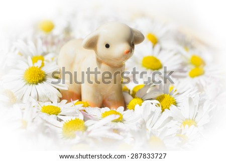 ceramic figurine sheep in floral swaddling clothes, bright edges