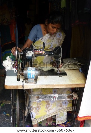 HAMPI, INDIA- CIRCA DECEMBER 2009:  Indian woman sews clothes circa December 2009 in Hampi, India.