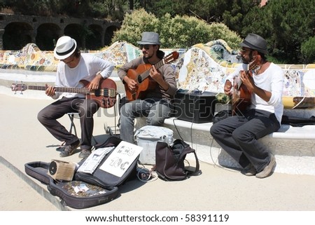 BARCELONA-JULY 13: musicians play for money at Parc Guell July 13, 2010 in Barcelona. Spain is going through economic hardship and many rely on tourists to make ends meet.