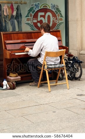 BARCELONA, SPAIN - JULY 15: male pianist playing in the street for money on July 16, 2010, in Barcelona, Spain. Spain is going through economic hardship these days.
