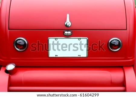 stock photo closeup on trunk of a red antique car and license plate